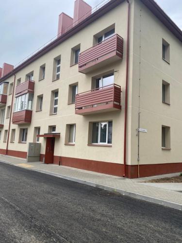 a building with balconies on the side of a street at Studio flat in Kedainiai in Kėdainiai