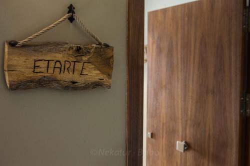 a sign that says fame hanging next to a door at Endaneta Berri in Zumaia