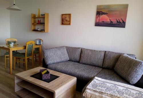 a living room with a couch and a table at Ferienwohnung mit Meerblick in Damp