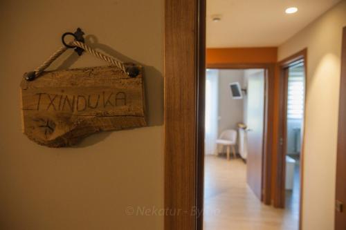 a sign hanging on a wall in a room at Endaneta Berri in Zumaia