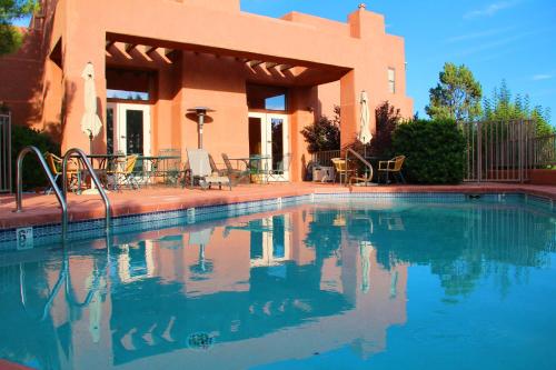 a swimming pool in front of a house at Alma De Sedona Inn B&B in Sedona