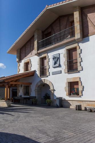 a large white building with a balcony and a patio at Endaneta Berri in Zumaia