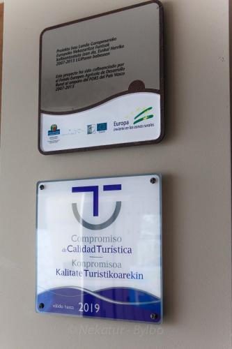 a sign on a wall with a sign for a call authorized transfer at Endaneta Berri in Zumaia