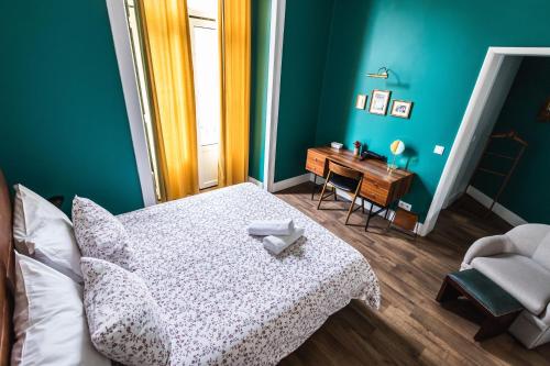 a bedroom with a bed and a desk and a chair at Home Lisbon Hostel in Lisbon