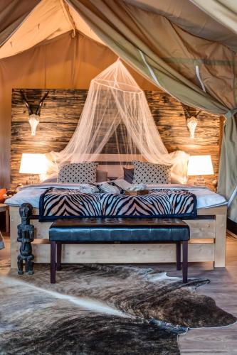 a bedroom with a bed in a tent at Glamping Safari - Africa House in Zlín
