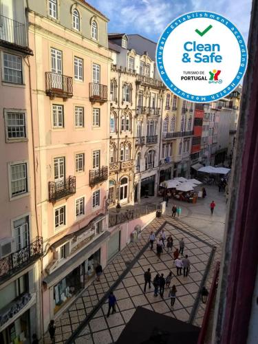 a group of people walking in a courtyard in front of buildings at Sweet Love Family I in Coimbra