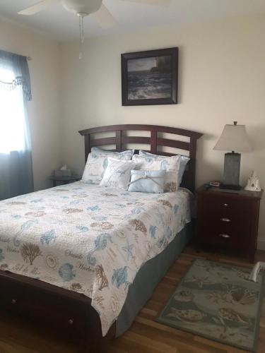 a bedroom with a bed and a lamp on a table at Ocean Front condo in the heart of Hampton Beach in Hampton