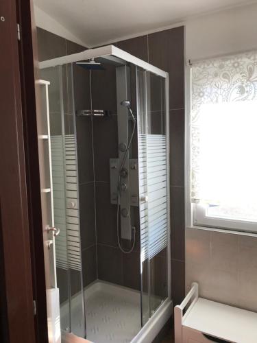 a shower with a glass door in a bathroom at Podere Venanzio in Lido di Camaiore