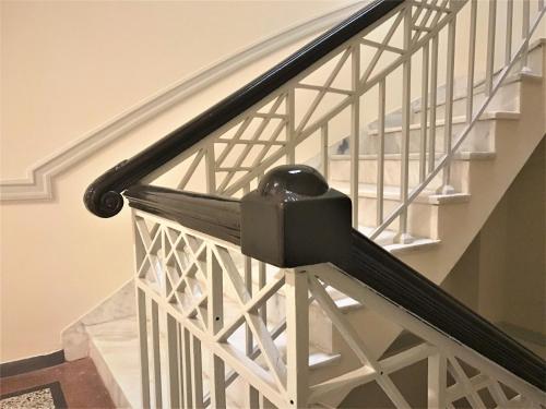 a staircase with a black hand rail and a stair case at Athens Psiri Hotel in Athens