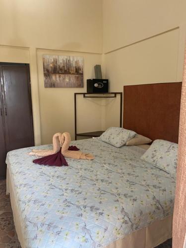 a bedroom with a bed with two towels on it at Gallina E Palo Beachfront Hotel in Jacó