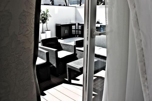 a view of a balcony with chairs and a table at Willa Exotic in Łeba
