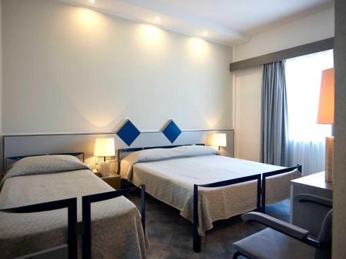 Postel nebo postele na pokoji v ubytování Grand Hotel Palace