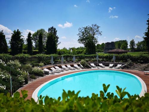 a swimming pool with chairs and umbrellas at Albergo dell'Agenzia in Bra