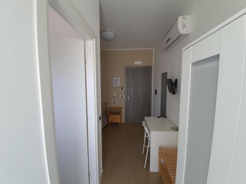 a hallway with a kitchen and a table in a room at Casale Marcalia - bed & breakfast in Corigliano Calabro