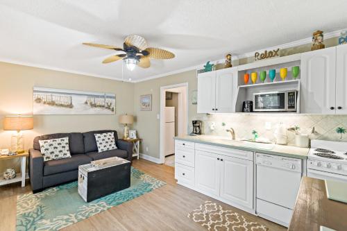 a living room with a couch and a kitchen at Villas by the Sea Resort & Conference Center in Jekyll Island