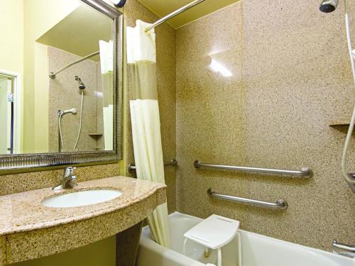 a bathroom with a sink and a toilet and a shower at La Quinta by Wyndham Houston New Caney in New Caney