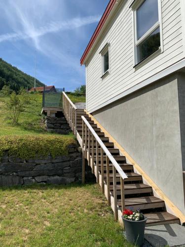 a house with a wooden staircase next to a building at Olden Fjord Apartments in Olden