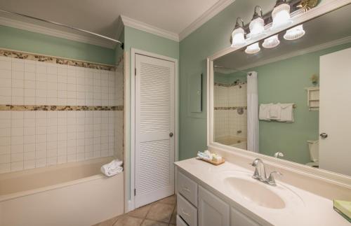 a bathroom with a sink and a mirror at Villas by the Sea Resort & Conference Center in Jekyll Island