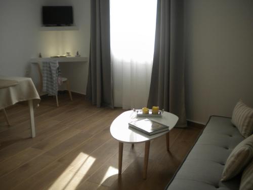 a living room with a couch and a table at Aeolia apartments in Ermoupoli