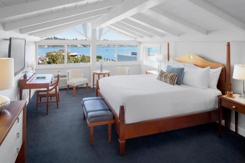 a hotel room with a bed and a desk and a table at Casa Madrona Hotel and Spa in Sausalito