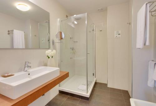 a bathroom with a sink and a shower at Best Western Plus Leone di Messapia Hotel & Conference in Lecce