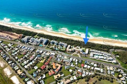 an aerial view of a beach with a blue arrow at By The Beach Relaxs - 3 Beds 2 Bath-Pool-Tennis-Golf in Marcoola