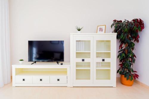 a white cabinet with a tv on top of it at Шикарная квартира на первой линии -Luxury apartment on the first line sea in Torrevieja