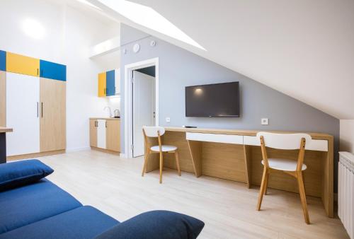 a living room with a desk and a tv at Partner Guest House Baseina in Kyiv