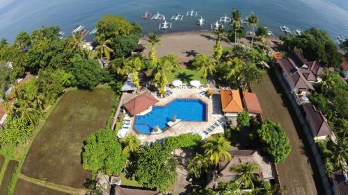 an aerial view of a house with a swimming pool and the ocean at Aneka Lovina Villas & Spa in Lovina