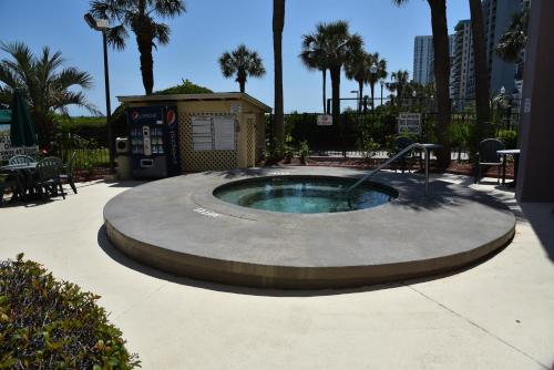 a small swimming pool with a fountain in a courtyard at Ocean Dream Vacation in Myrtle Beach