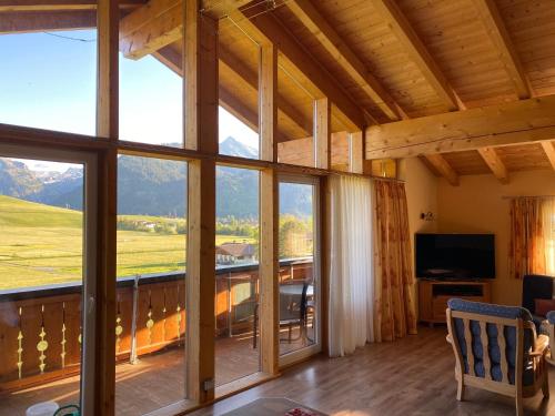 a living room with a view of a mountain at Sonnleiten - Guggerhof - Villa Sonnenwies in Tannheim