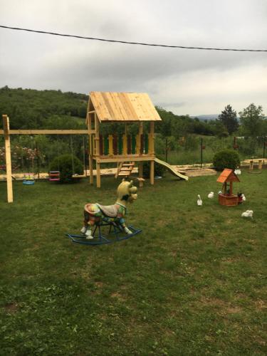 a toy goat on a sled in a playground at Apartment Pavlovic in Soko Banja