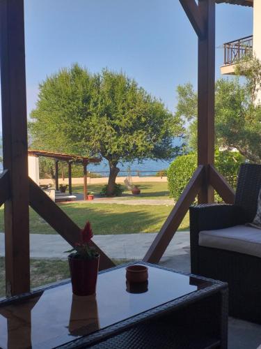 a patio with a table and a view of the ocean at Barbagiannis House in Ormos Panagias