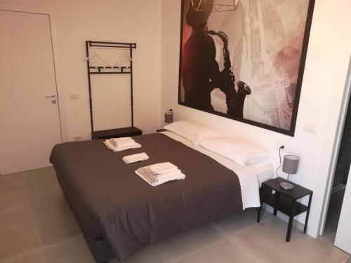 a bedroom with a bed with two towels on it at SMART Rooms Pistoia in Pistoia