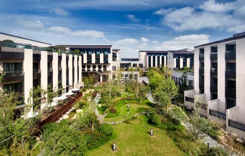 an aerial view of a campus with buildings at Hyatt Regency Chongming in Chongming