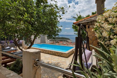 a swimming pool in a yard with a house at Villa Sukara in Makarska