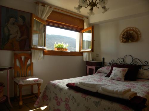 a bedroom with a bed and a window at Casa el Sotillo in Villoslada de Cameros