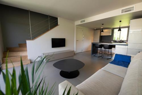 a living room with a couch and a table at Costa Nera Beach House in Porto-Vecchio