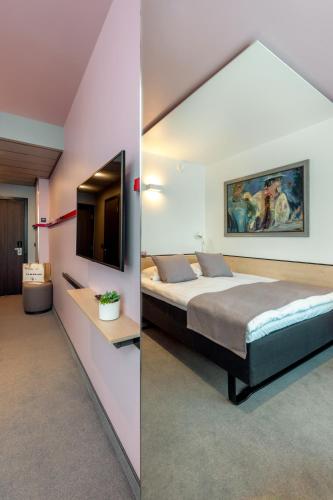 Postel nebo postele na pokoji v ubytování Art Hotel Pallas by Tartuhotels