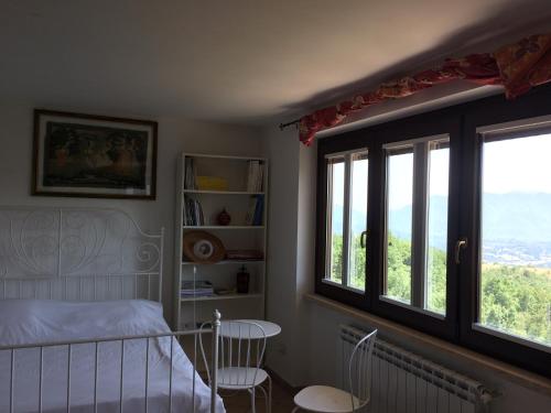 AlvitoにあるCominium Benessereのベッドルーム1室(ベッド1台、テーブル、窓付)