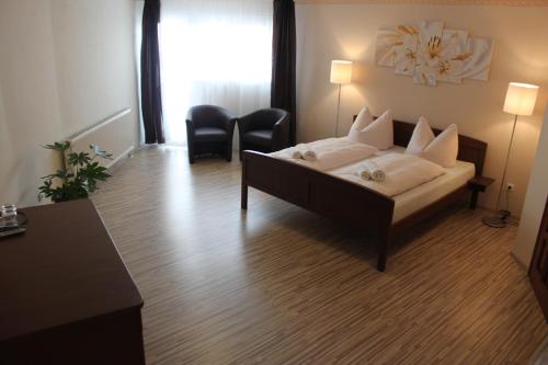 a hotel room with a bed and a table and chairs at Zlatý lev in Svitavy