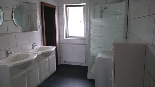 a bathroom with a sink and a toilet and a window at Mario's fachwerkhaus am Huy in Schlanstedt