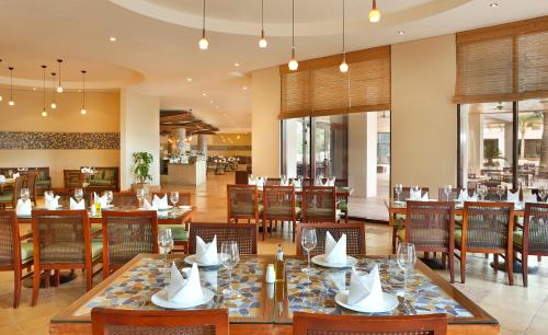 a dining room with tables and chairs in a restaurant at InterContinental Aqaba by IHG in Aqaba