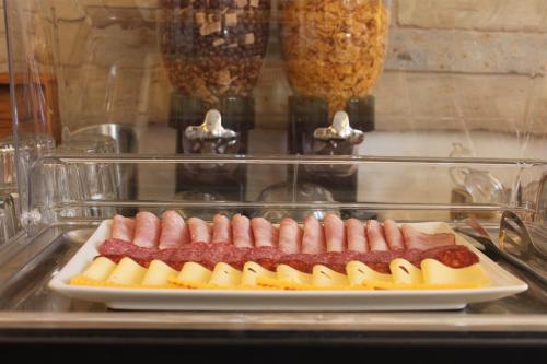 a plate of sausages and cheese on a table at Zlatý lev in Svitavy