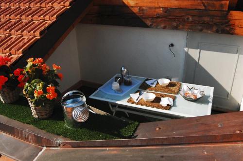 a table with a plate of food and a sink at Il Bosso del Lago d'Orta in Ameno