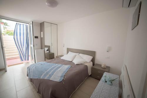 a bedroom with a bed and a large window at Villa Lara in Polignano a Mare