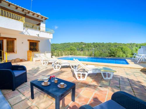 a villa with a swimming pool and a patio at Holiday Home Amarilla by Interhome in Pedramala