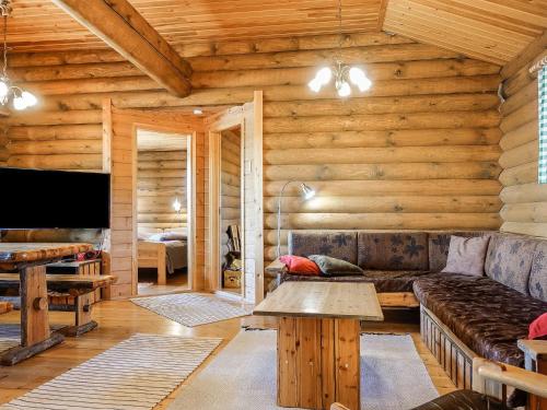a living room with a couch and a table at Holiday Home Inarinlahti by Interhome in Inari
