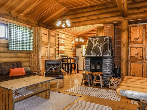 a living room with a fireplace in a log cabin at Holiday Home Inarinlahti by Interhome in Inari