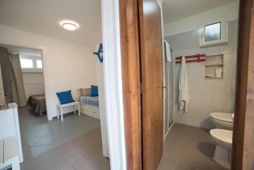 a bathroom with a toilet and a sink in a room at Villa Lara in Polignano a Mare
